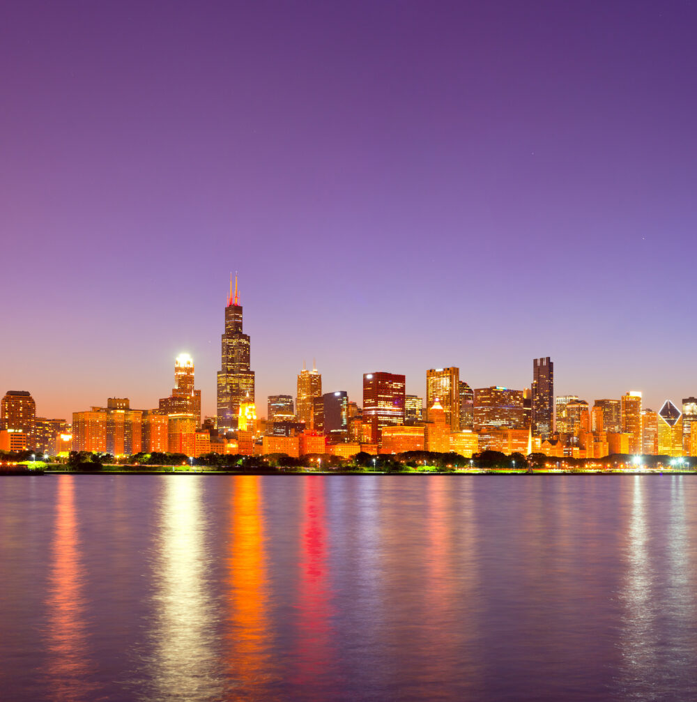 City of Chicago USA, sunset colorful panorama skyline of downtown with illuminated business buildings with reflections