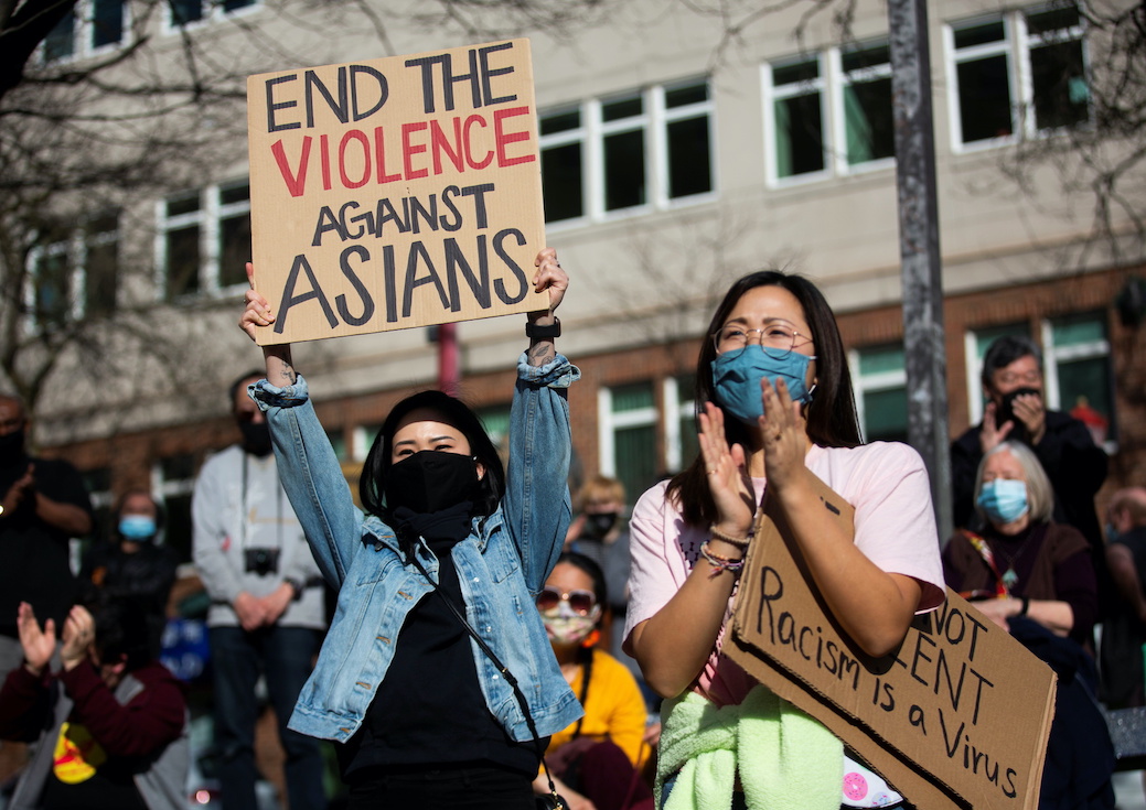 Cheung and Do clap during a protest against anti-Asian hate crimes in Seattle