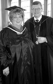 Garrett-Evangelical 2002 Distinguished Alum Marsha Woolley poses for a photo in graduation robes